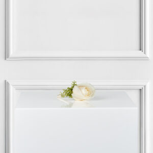 Add timeless elegance to your look with our White Rose Boutonniere