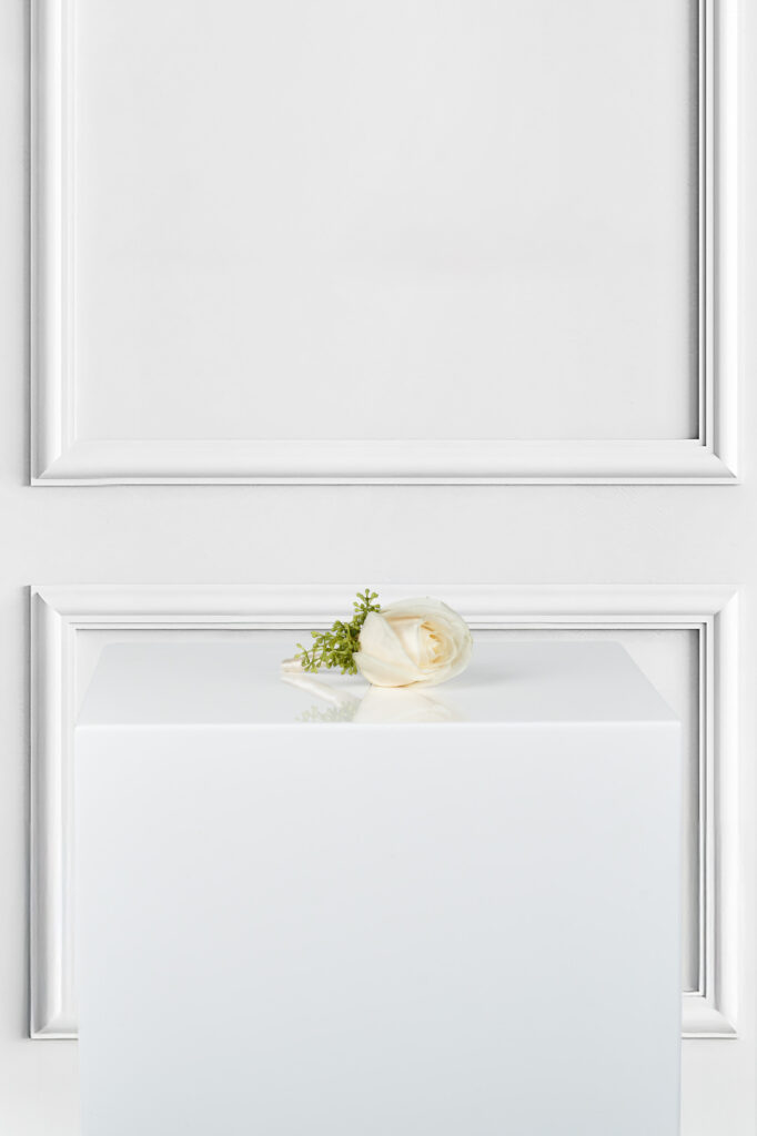 Add timeless elegance to your look with our White Rose Boutonniere